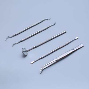 Dental tools and model of teeth on a blue background. Dental care concept.