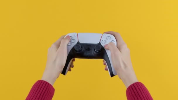 Oyuncuların Elleri Playstation Ps5 Konsol Televizyonunda Sarı Arka Planda Joystick — Stok video