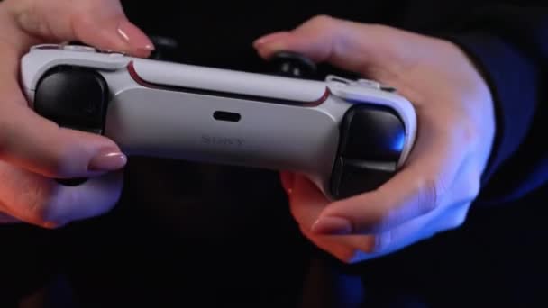 游戏玩家在Playstation Ps5控制台电视上用霓虹灯下的操纵杆进行在线视频游戏 女人按下按钮 使用操纵台双感控制器 高质量的4K镜头 — 图库视频影像