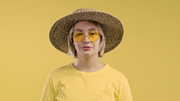 友善的女孩表现出肯定的信号点头表示同意戴着帽子的积极的 阳光灿烂的女人 身体语言 正确的完美选择 很大程度上 黄色背景 高质量的4K镜头 — 图库视频影像