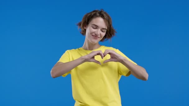 Freundliche Frau Die Zeichen Der Form Herz Zeigt Blauer Hintergrund — Stockvideo