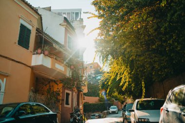 Beautiful cozy narrow street in old town of Italy or Greece. Historic european facades of buildings. Cityscape concept. High quality photo clipart