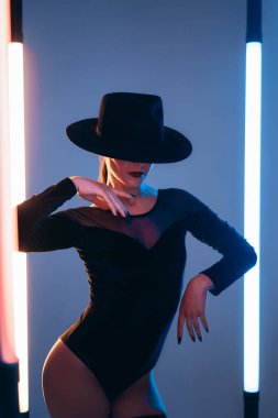 Yanıp sönen neon ışıklar ve stüdyo arkaplanı arasında çekici bir kadın. Ölümcül kadın, şık bir balerin kıyafeti. - Evet. Yüksek kalite fotoğraf