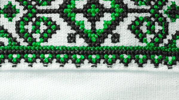 Handmade embroidery on Ukrainian shirt. Geometric ornaments, ancient traditional authentic clothes of Ukrainians. Colorful screen saver, vyshyvanka. Ethnic craft. High quality photo