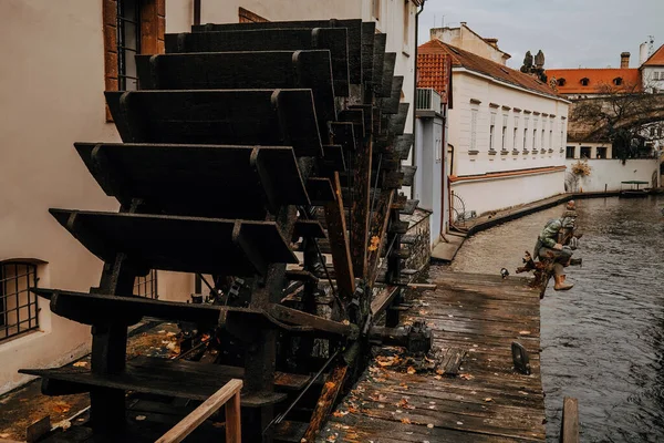 Old historic wooden water mill on Kampa Island in Prague, canal river. Devil's Stream. High quality photo