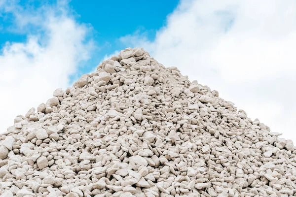 stock image Sorted limestone rock in embankment. Open pit mining quarry. Extractive industry, grey background. Construction site, geology concept.