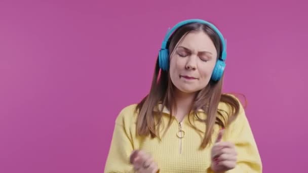 Happy Woman Listening Music Enjoying Dance Headphones Pink Studio Backdrop — Stock Video