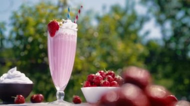 Hayat devam ediyor. Kremalı çilekli milkshake kokteyli ya da samanlı buzlu meyve suyu. İştah açıcı yaz tatlısı. Sağlıklı dut yemeği. Yüksek kalite 4k görüntü