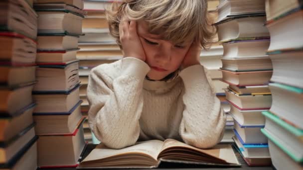 Bored Little Schooler Boy Reading Sitting Classroom Library Desk Sad — Stock Video