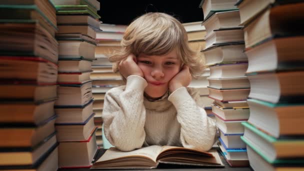 Bored Little Schooler Boy Sighs While Sitting Classroom Library Desk — Stock Video