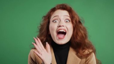 Şaşırmış kadın, vay canına diyor. İlgi çekmeye çalışan etkileyici öğrenci ya da iş kadını. Satış kavramı, karlı bir teklif. Yeşil arka planda heyecanlı romantik bir kız. Yüksek kalite 4k