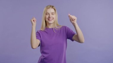 Güzel, 30 'lu yaşlarda eğlenen, en sevdiği müziği çalan, gülümseyen, Violet stüdyosunda dans eden bir kadın. Müzik, dans konsepti, 4k