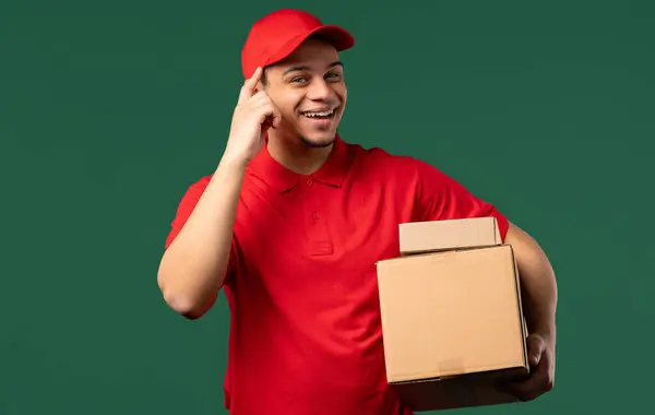 stock image Multiracial clever positive postal courier man with gesture - you, think about it. Looking camera on green. Thinking positive. Intelligent person. High quality photo