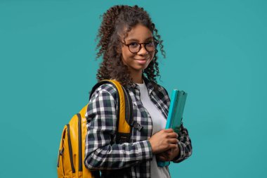 Elinde kağıt klasörüyle gülümseyen Afro-Amerikan öğrenci portresi. Akademik gençlik, eğitim, üniversite konsepti. Yüksek kalite 