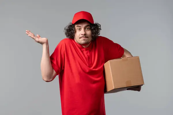 stock image Confused postal courier man, shoulders up - can't help,makes gesture I dont know. Difficult question, guilty reaction, puzzled guy on white background. High quality