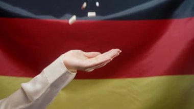 Almanya 'nın Bayrak Altında Kadın Eline Düşen Haplar. Pahalı bir ilaç. Eczacılık işi. Eczane temalı. Deutschland 'da çok renkli ilaç ve kapsüller. Yüksek kalite 4k görüntü