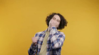 Olgun bir adam zaferi gösterir. Zaferin jesti, başarıya, amaca ulaşmıştır. Mutlu, mutlu, şaşırmış, sarı arka plandaki mutlu adam. Büyük ikramiye konsepti. Yüksek kalite 4k