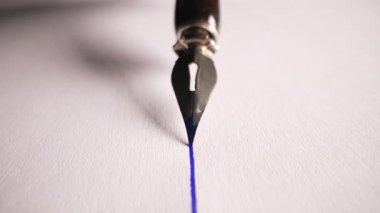 Antika Çeşme kalem ucu kağıt üzerinde pürüzsüz bir şekilde süzülerek mürekkep izi bırakıyor. Sanatsal görsel, çizim çizgisi, lüks kırtasiye konsepti. Yüksek kalite 4k görüntü