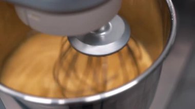 Badem ununu ipek dokuya harmanlayan stand mikserinin yakın çekim görüntüsü. Hassas hamur işleri için mükemmel. Makaronlar, tartlar, glütensiz fırınlar. Pişirme, tatlı görselleri. Yüksek kalite 4k görüntü