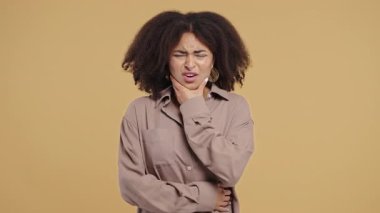 Bej renkli stüdyo geçmişinde diş ağrısı olan güzel bir Afrikalı Amerikalı kız. Diş ağrısı, diş sorunları, diş hekimliği ve tıp konsepti