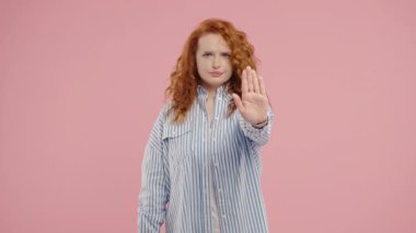 Kadın model elini görünür bir dur hareketiyle kaldırıyor ve güçlü bir sınır sinyali gönderiyor. Kişisel alan, güvenlik, reddetme, davranış kontrol temaları