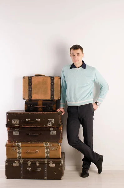 Portrait Young Man Blue Jumper Black Pants Standing Stack Suitcases — Stock Photo, Image