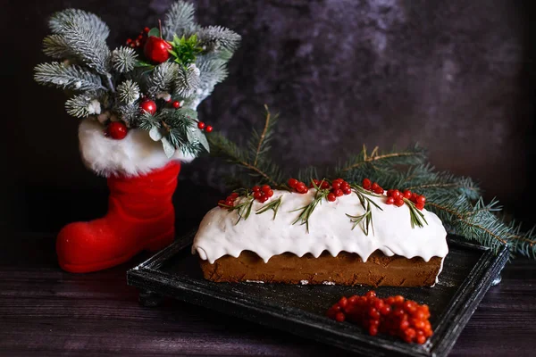 节日纸杯蛋糕 在圣诞靴旁边的一个深色盘子里装饰着维本酒 — 图库照片
