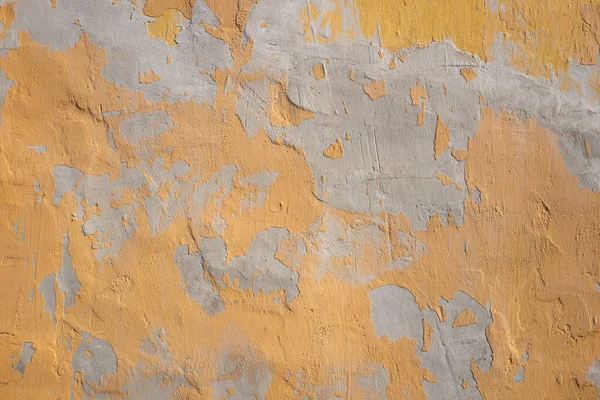 old orange paint on the background of an old wall
