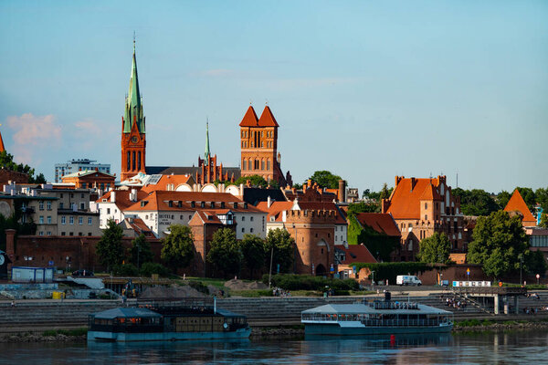 04-07-2022: View of Old City of Torun. Vistula (Wisla) river against the backdrop of the historical buildings of the medieval city of Torun. Poland.