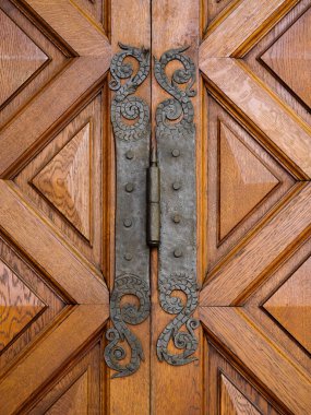 old metal door hinged against the background of an wood door clipart