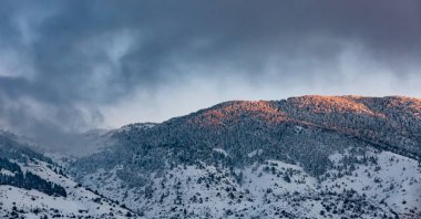 Beautiful Landscape of High Mountain Covered with Snow in the Mist. Mild Sunset Light. Winter Cold Weather. Lebanon.