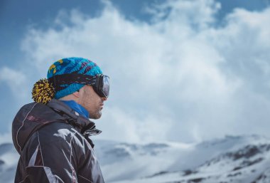 Profile Portrait of a Man Enjoying Landscape. Winter Sport in the Mountains. Wintertime Vacation. Active People Lifestyle.