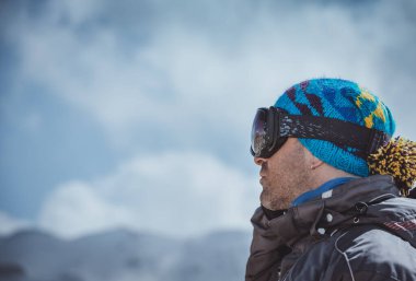 Profile Portrait of a Man Enjoying Landscape. Winter Sport in the Mountains. Wintertime Vacation. Active People Lifestyle.