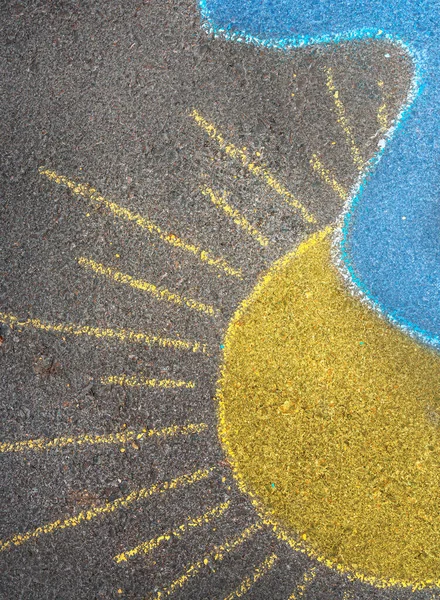 Beautiful abstract border. Hand drawing chalk picture on asphalt of a yellow sun and blue cloud. Conceptual photo of Ukrainian flag. Stop war.