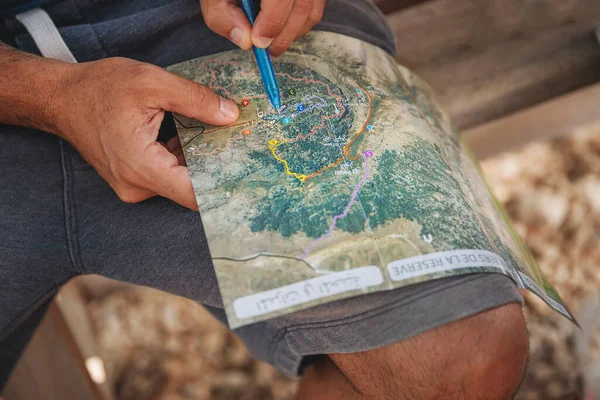 森林里一个活跃的旅行者的概念性照片 一张男子在地图上寻找正确目的地的特写照片 — 图库照片