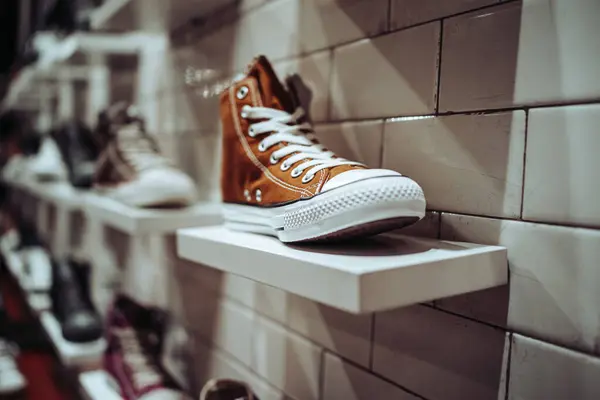 Stylish, fashionable, youth shoes. Cool vintage sneakers stand on the shelf of a vintage store. Everyday fashion.