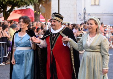 Teggiano, Italy - August 11, 2024, Medieval Festival : Everybody at the table with princess Costanza. clipart