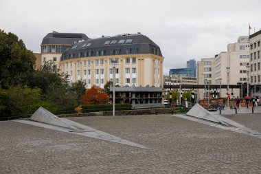 Brussels, Belgium - September 17, 2022: City view with various buildings, a circular paved square in the foreground and a cloudy sky in the backgroun