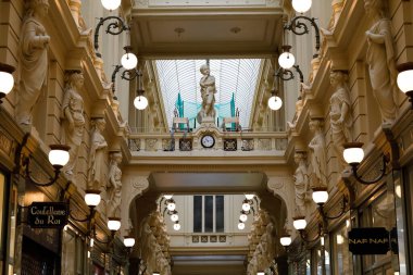 Brussels, Belgium - September 19, 2022: Upper, inner part of the glazed shopping arcade is decorated with carvings and other elements. The shopping mall is called Passage du Nord , Northern Passage.