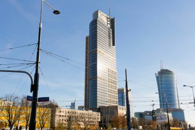 Warsaw, Poland - November 8, 2022: A modern skyscraper, an office building is visible above other buildings, here in Wola distric