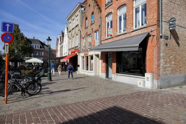 Bruges, Belgium - September 12, 2022: Traditional houses line the street in the old part of this medieval town. There are cobbled streets with little or no traffic and only a few pedestrians