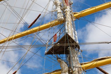 Gdynia, Poland - May 27, 2022: Fragment of the three masts of a sailing ship with rigging. It is a Polish training ship, frigate type, built at the Gdansk Shipyard in 1982, called Dar Mlodziezy
