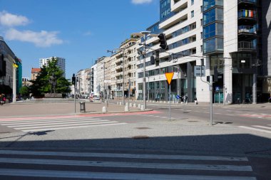 Gdynia, Poland - June 3, 2022: Multi-story, multi-family residential buildings along the high street leading through the city. There is little traffic now.