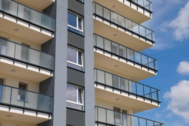 Warsaw, Poland - July 3, 2022: Facade and balconies of modern multi-storey residential building in the Goclaw housing estate, in the Praga Poludnie district of the city of Warsaw.