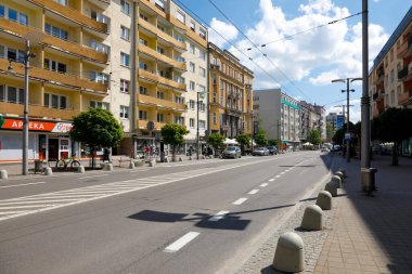 Gdynia, Poland - June 3, 2022: Multi-story, multi-family residential buildings along the high street leading through the city. There is little traffic now