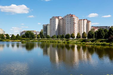 Warsaw, Poland - August 7, 2022: Overall view of the multi-storey residential buildings by the park and lake in the Goclaw estate, in the Praga Poludnie district