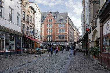 Brussels, Belgium - September 16, 2022: Slowly the evening approaches the streets of the old town. People are walking along the cobbled street