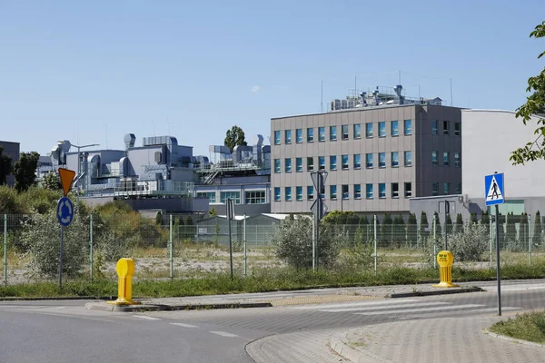 Warsaw, Poland - September 2, 2022: Behind the fence there are buildings that are part of a research and industrial institution located in the Goclaw estate in the Praga Poludnie district