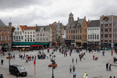 Bruges, Belçika - 15 Eylül 2022: Pazar Meydanı 'nın köşesindeki evlerin genel görünümü. Bu büyük meydanda bir sürü insan var.