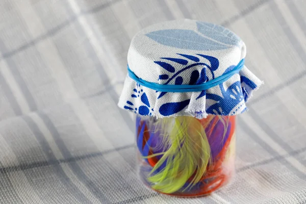Small Jar Colorful Feathers Topped Piece Fabric Secured Blue Rubber — Fotografia de Stock